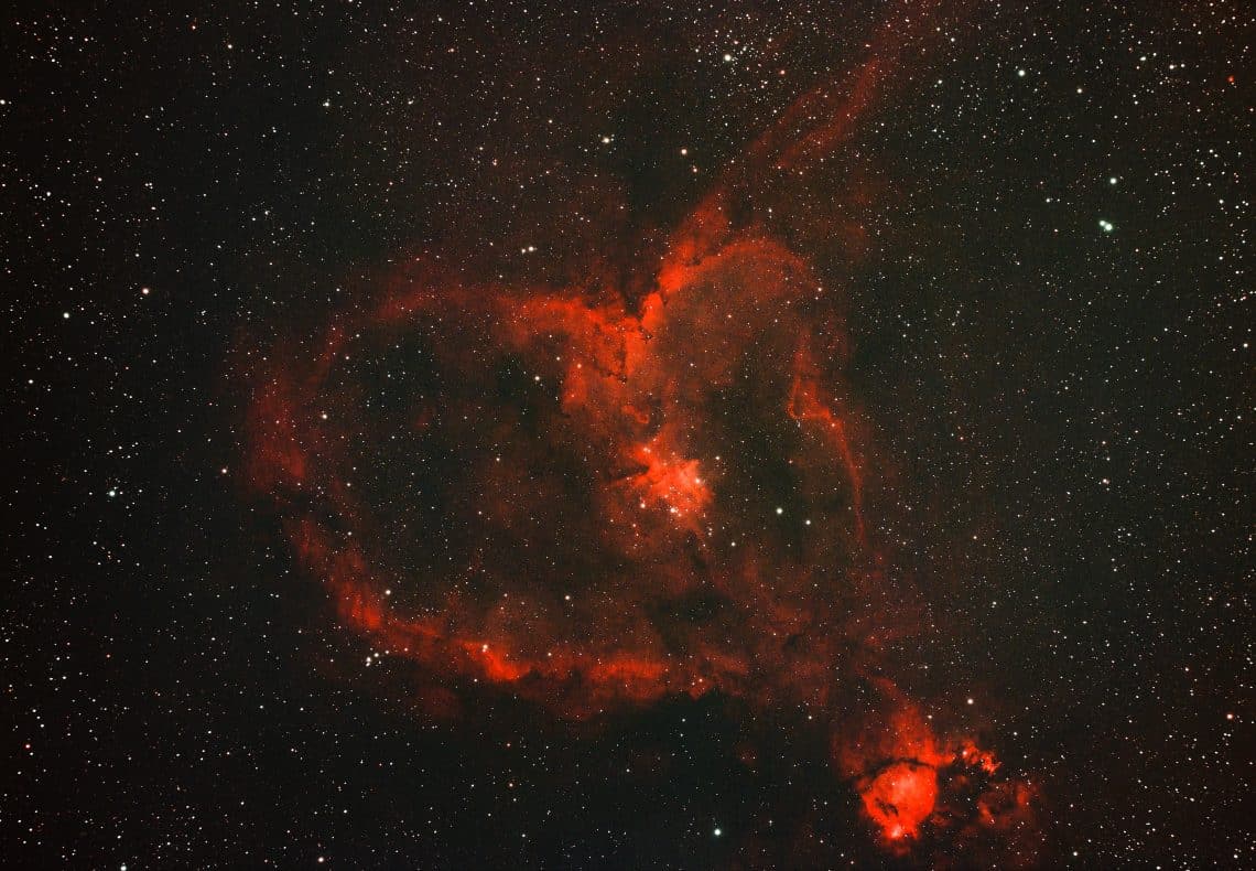 A red heart nebula in starry space.