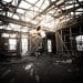 Girl flying into a beam of light in an abandoned warehouse.