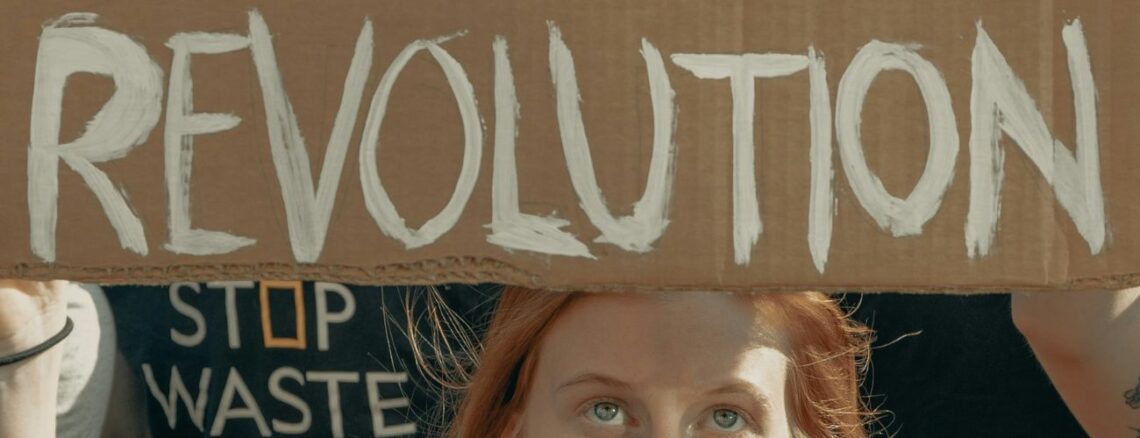 Girl holding Revolution sign at a protest