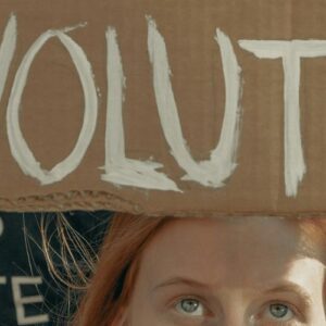 Girl holding Revolution sign at a protest